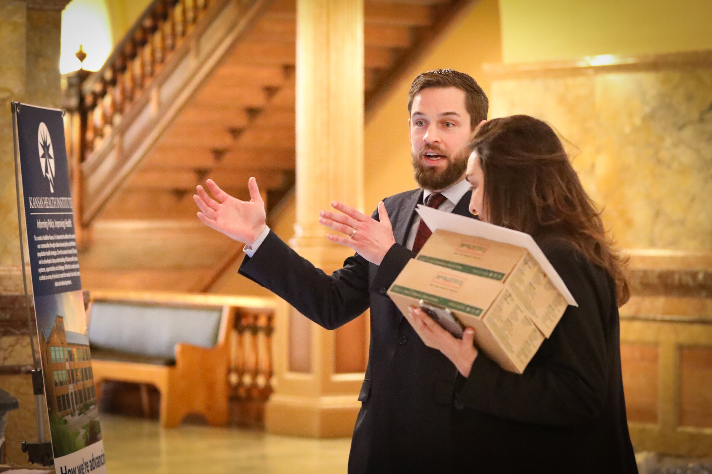 KHI staff explain County Health Rankings information at the Kansas Statehouse