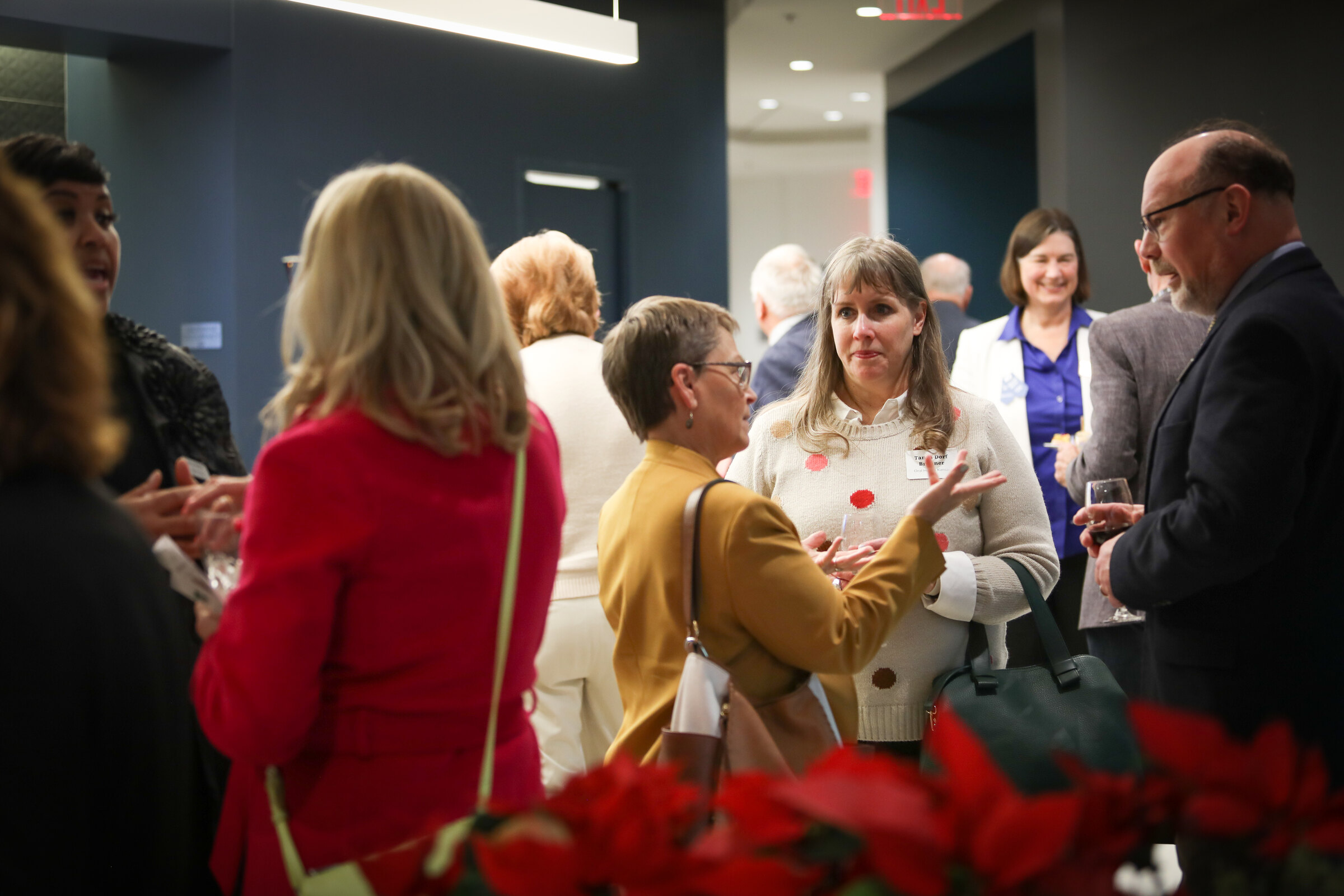 Guests converse at a KHI legislative open house